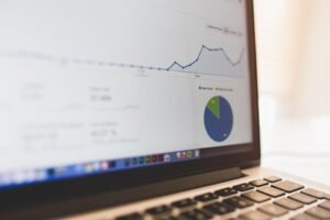 Laptop screen showing a website traffic analytics dashboard with graphs and charts
